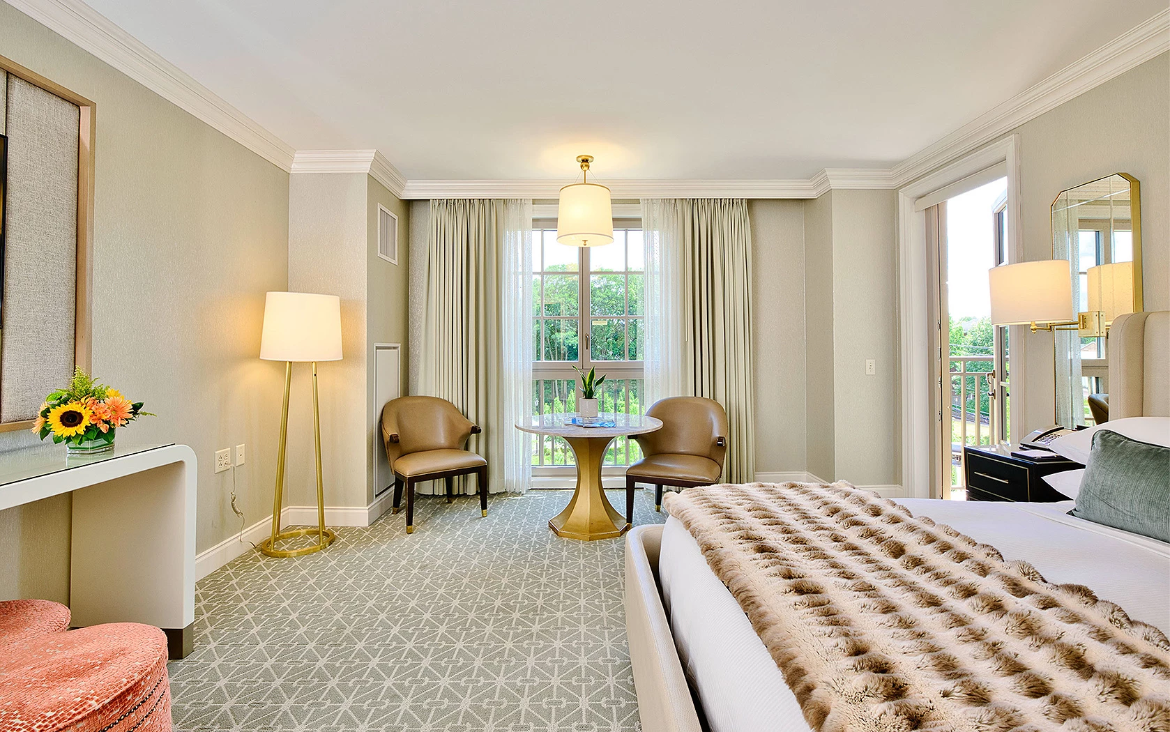 A room with lamps, a bed, and sofa couches