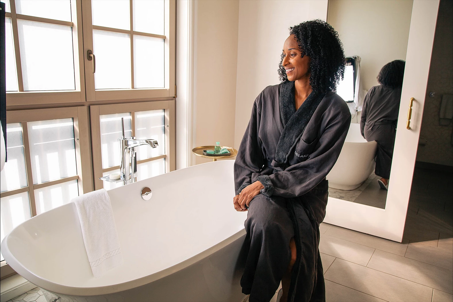 a person standing next to a bathtub
