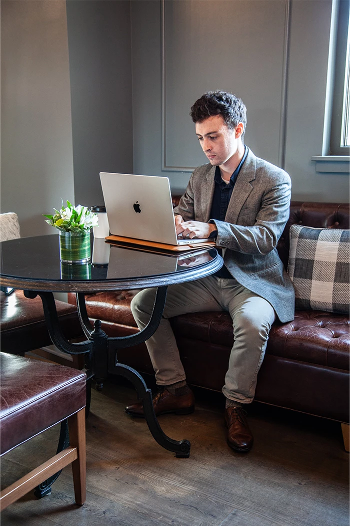 a man sitting on a couch with a laptop