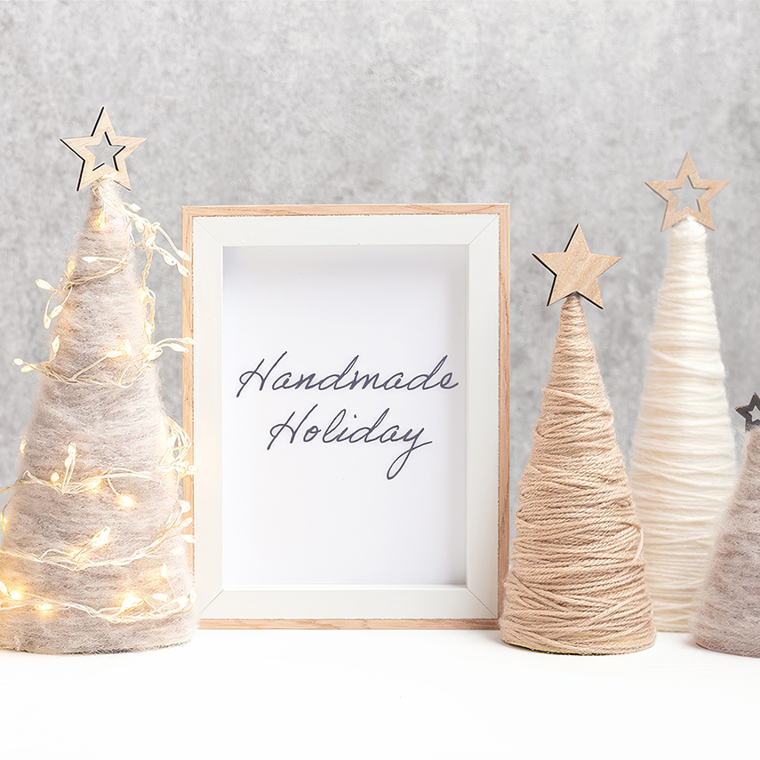a group of christmas trees with string lights and a frame