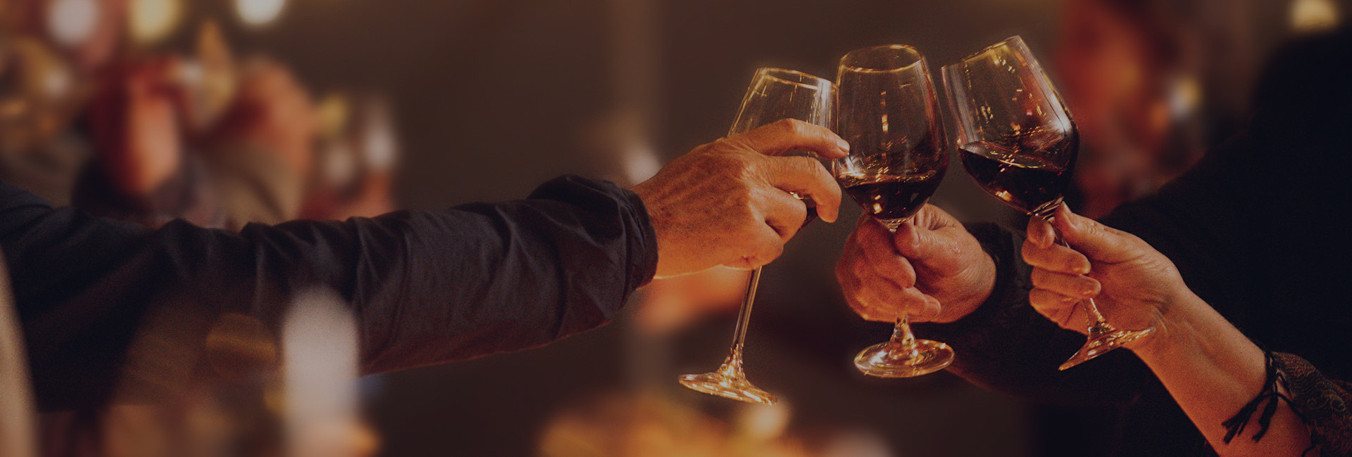 a group of people holding wine glasses