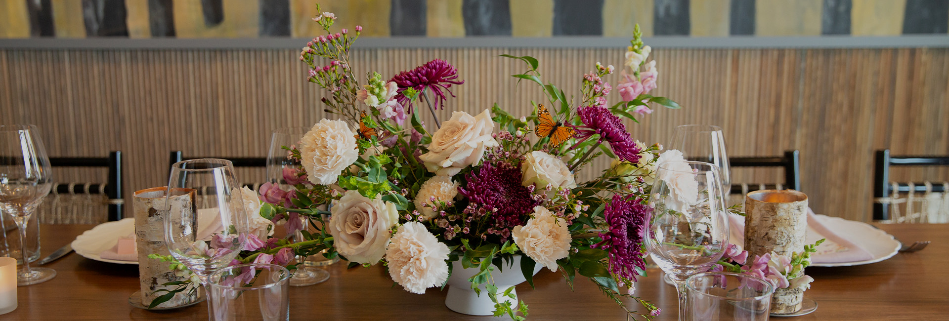 a table with flowers and glasses