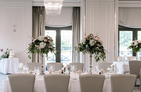 a dining room with white tables and chairs