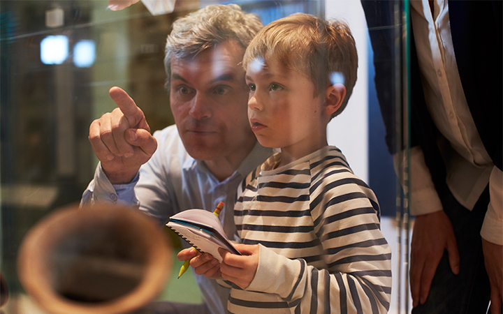 a man and boy looking through a window