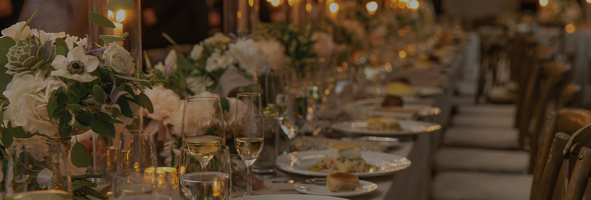a table with plates of food and glasses of wine