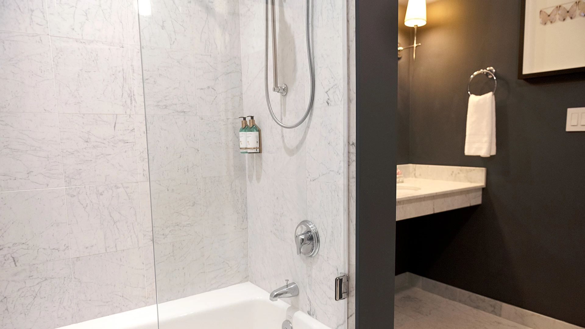 A bathroom with a shower, bathtub, and sink