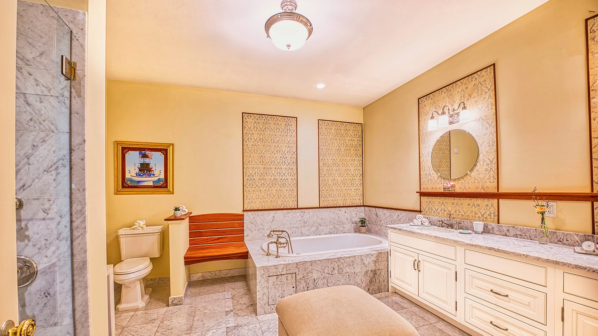 A luxurious bathroom with marble tiles, a double vanity, a soaking tub, and a separate shower.