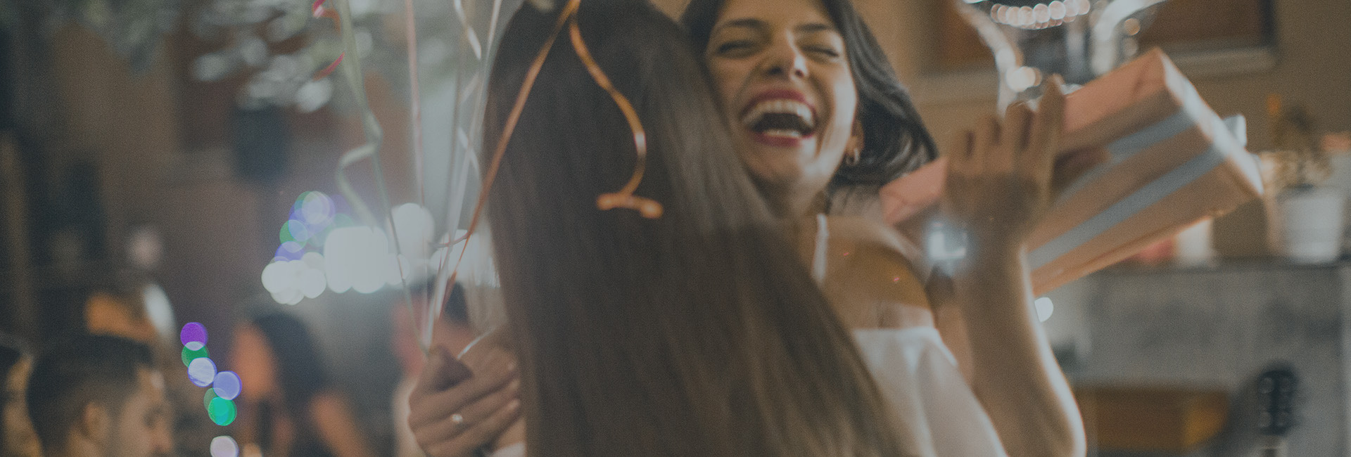Two woman hugging and laughing