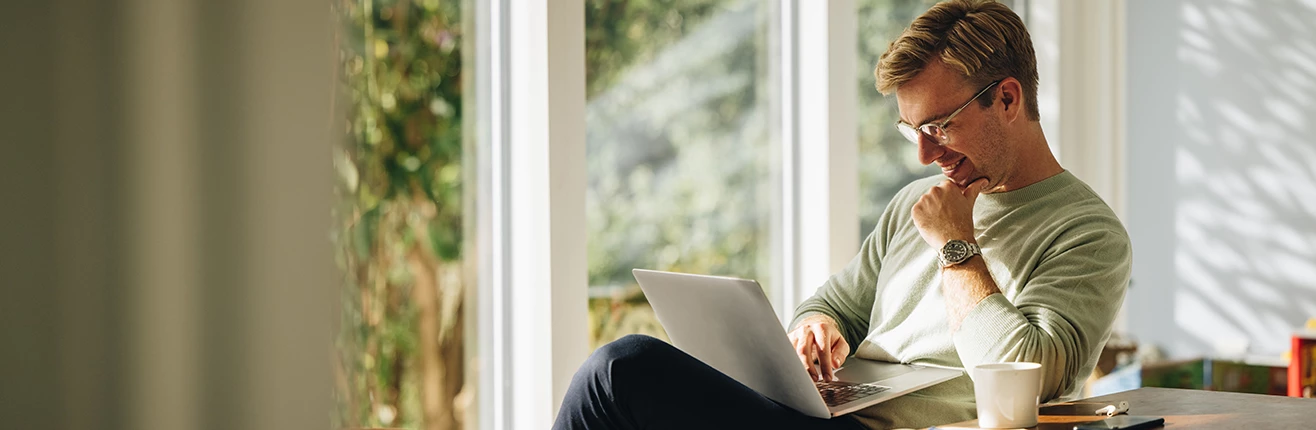 a woman sitting on a chair using a laptop