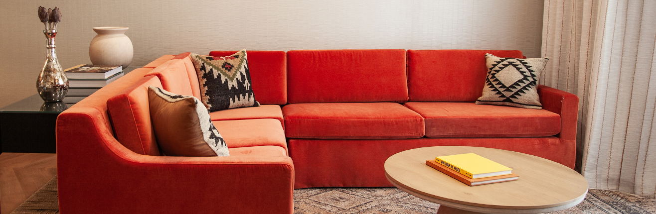 a couch with a coffee table and a book