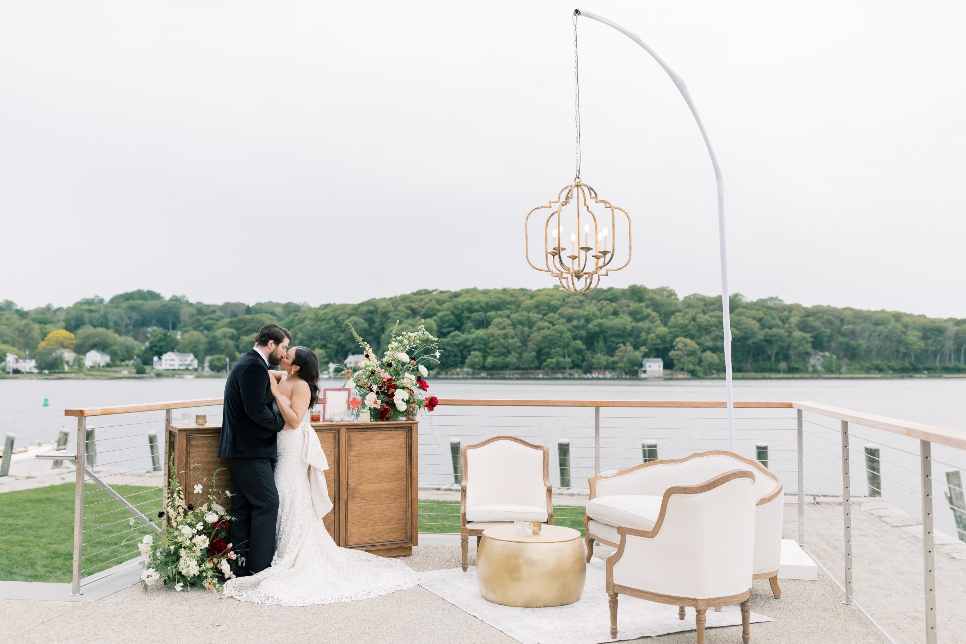 a man and woman kissing under a chandelier