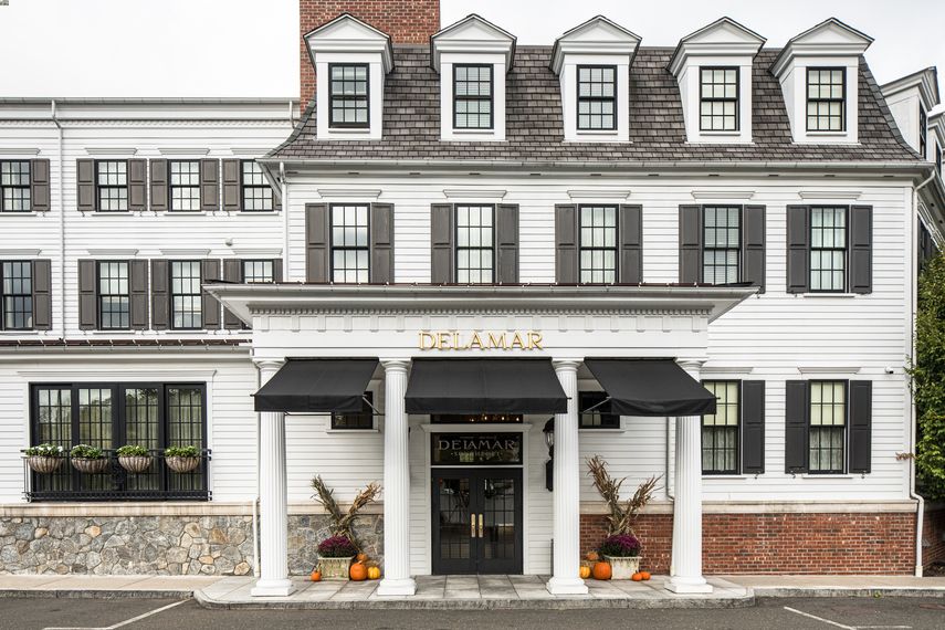 a building with black awnings and pumpkins