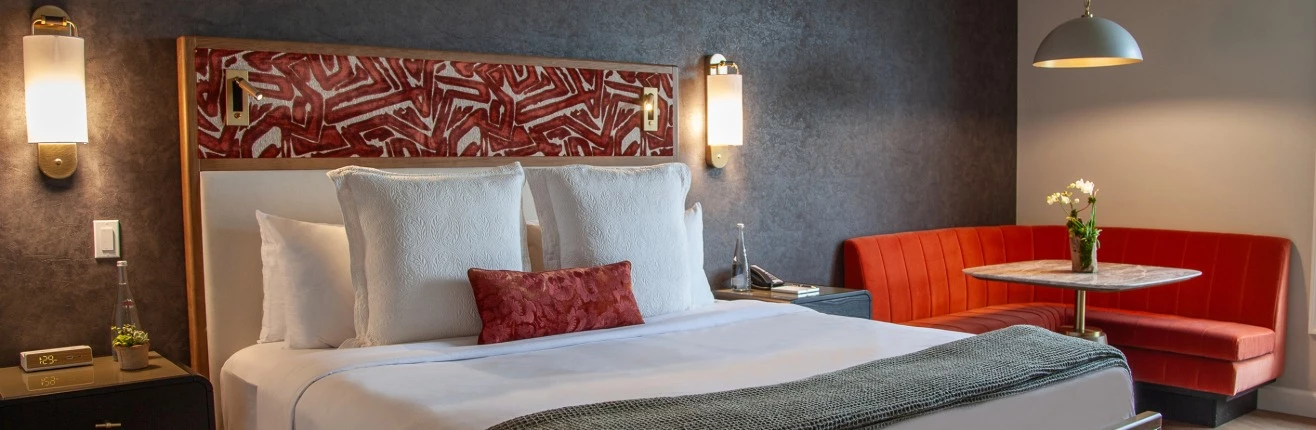 a bed with pillows and a lamp