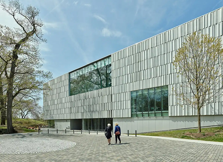 two people standing outside of a building