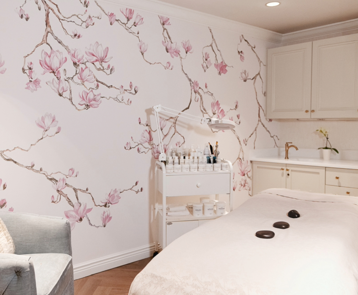 a room with a bed and a table with a wallpaper