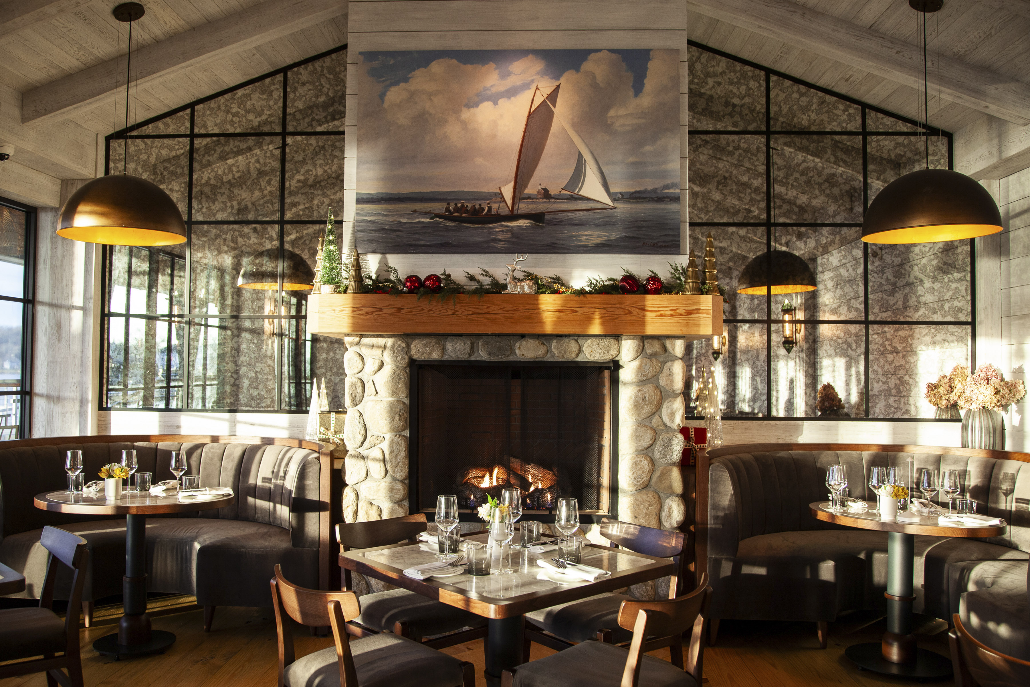 a room with a fireplace and tables and chairs