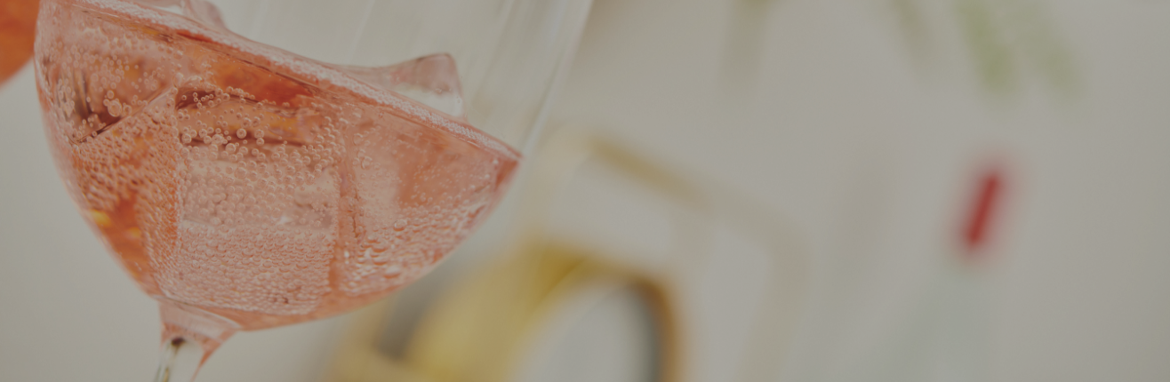 a close up of a glass of pink liquid