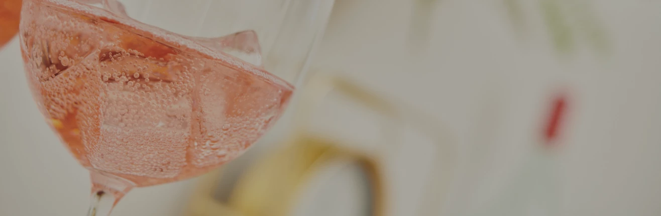 a close up of a glass of pink liquid