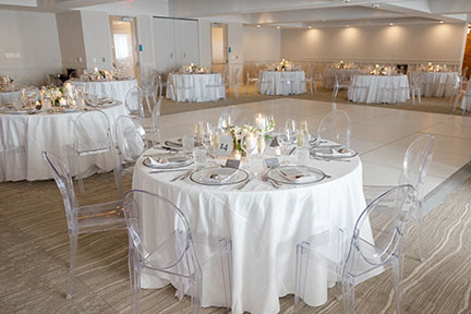 a room with tables and chairs for wedding