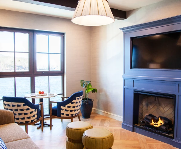 a room with a fireplace and a table and chairs