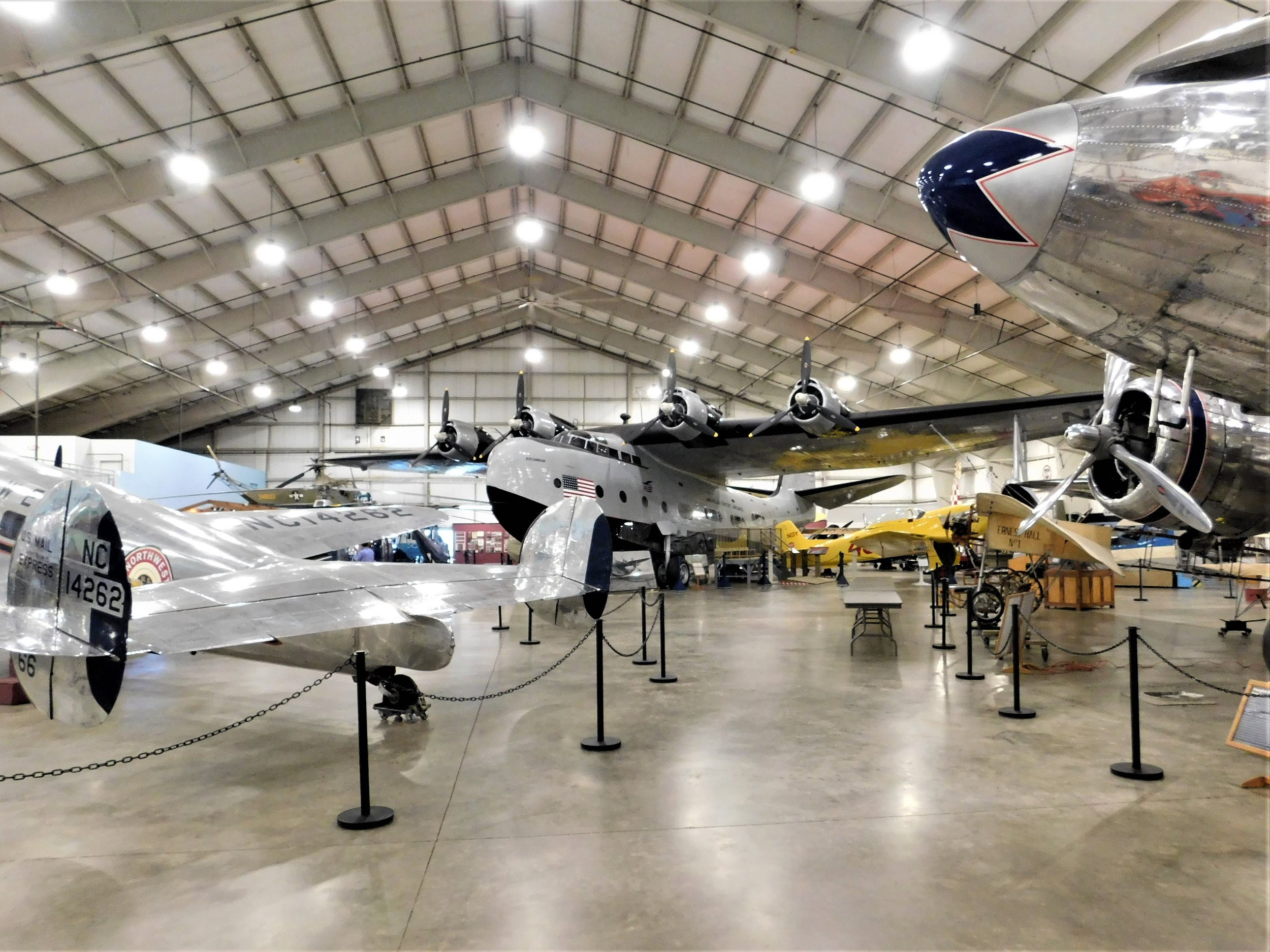 a large hangar with airplanes in it with Lone Star Flight Museum in the background