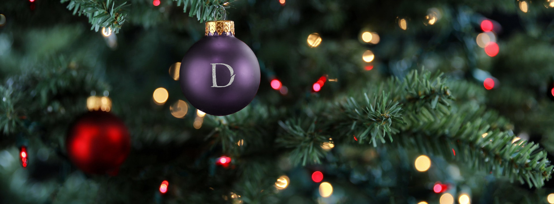 a purple ornament with a letter on it