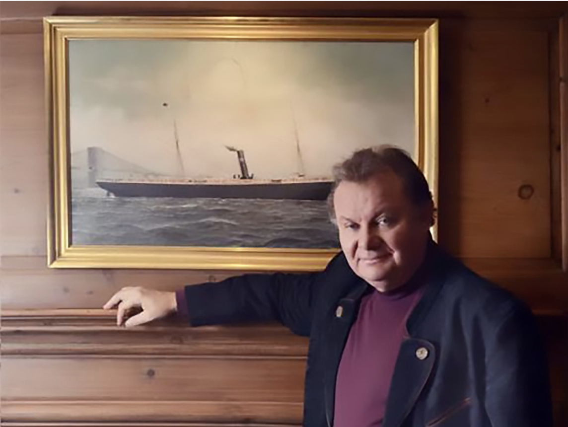 a man leaning on a wall with a painting on it