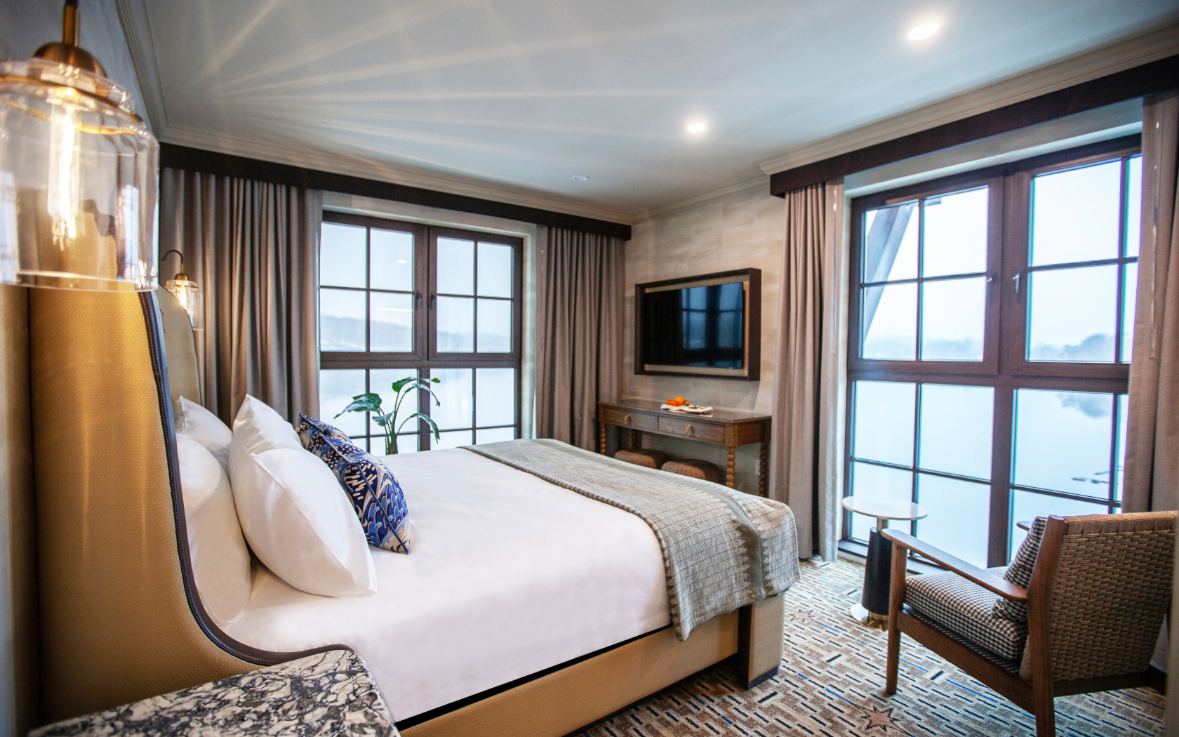 a bedroom with a bed and a television