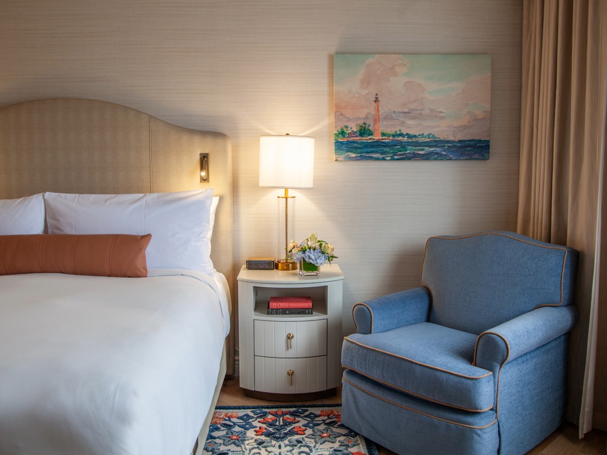 a bedroom with a bed and a lamp