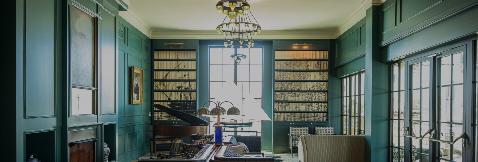 a room with a piano and a chandelier