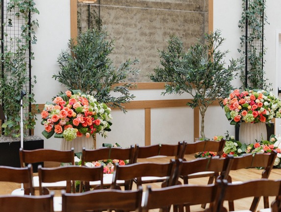 a room with chairs and flowers