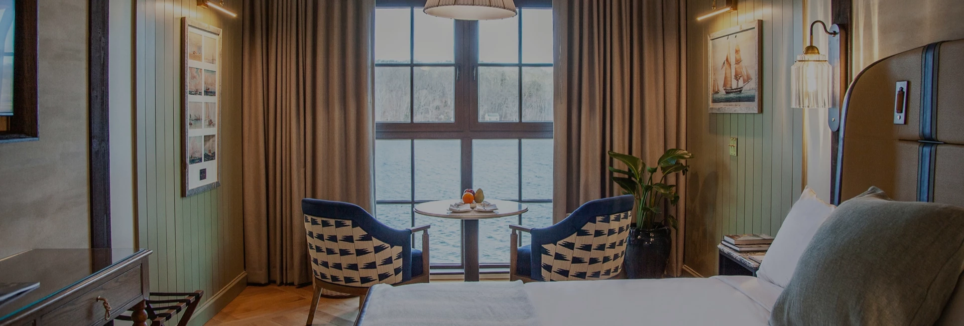 a room with a table and chairs by a window