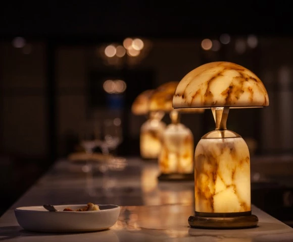 a table with a lit up lamp