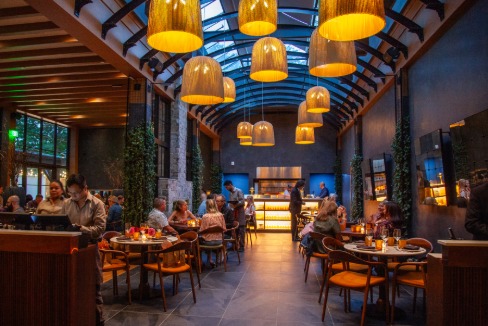 a group of people sitting at tables in a restaurant