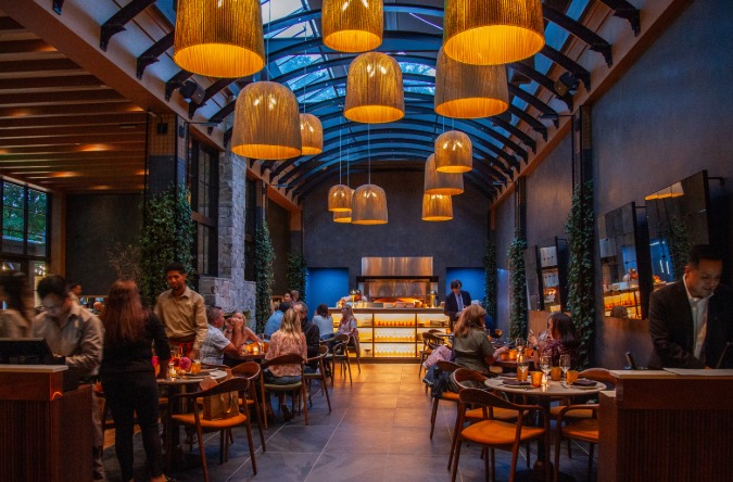 a group of people sitting at tables in a restaurant