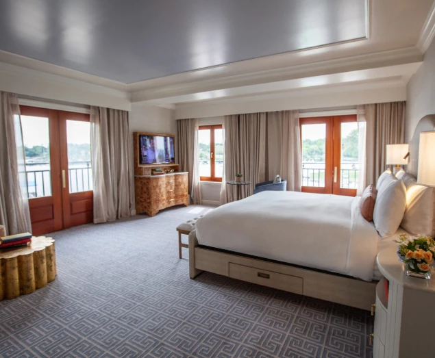 a room with a bed and a television