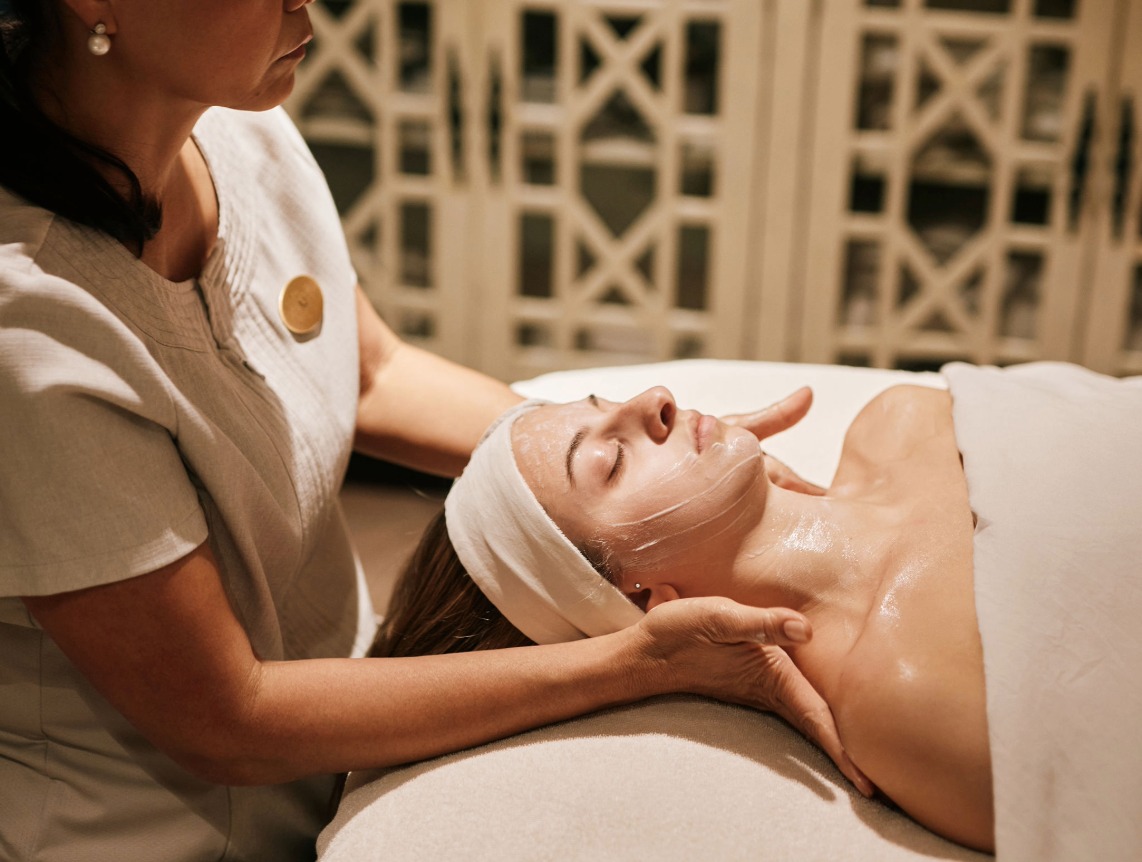 a woman receiving a facial massage
