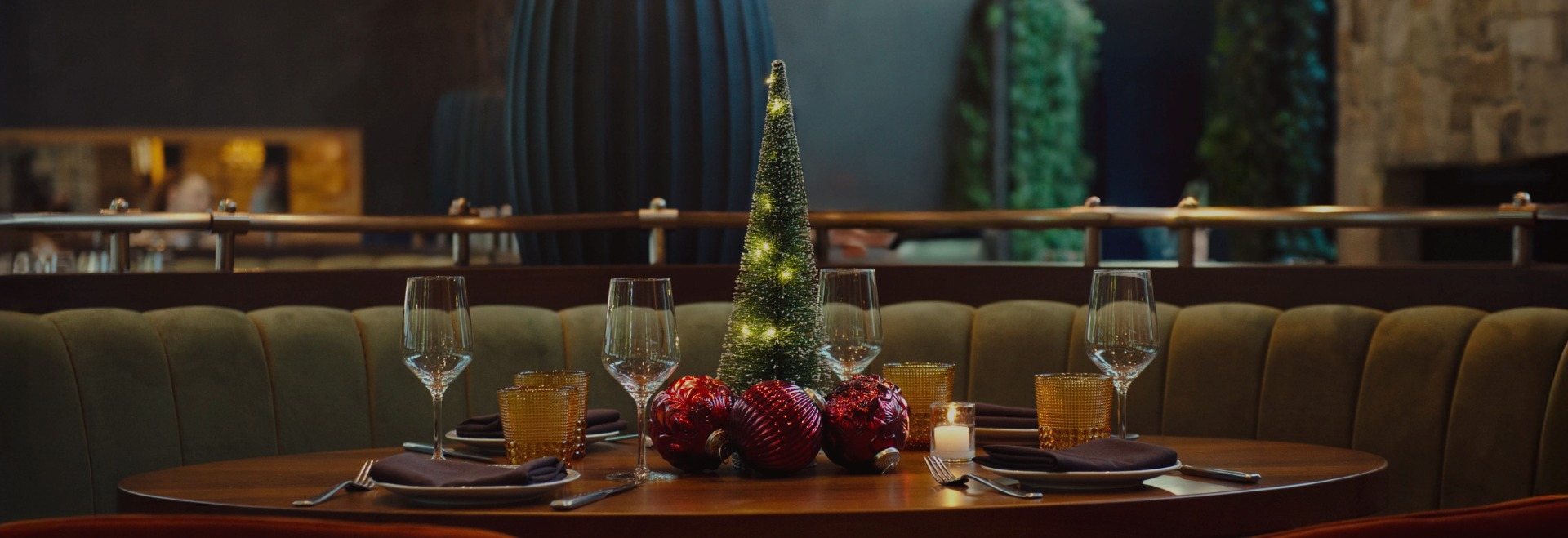 a table with a tree and candles
