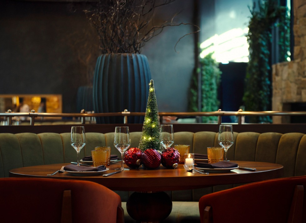 a table with a small tree and glasses on it
