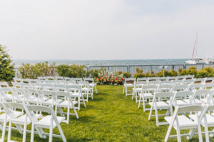 a group of white chairs in a grassy area