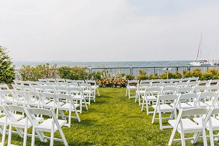 a group of white chairs in a grassy area