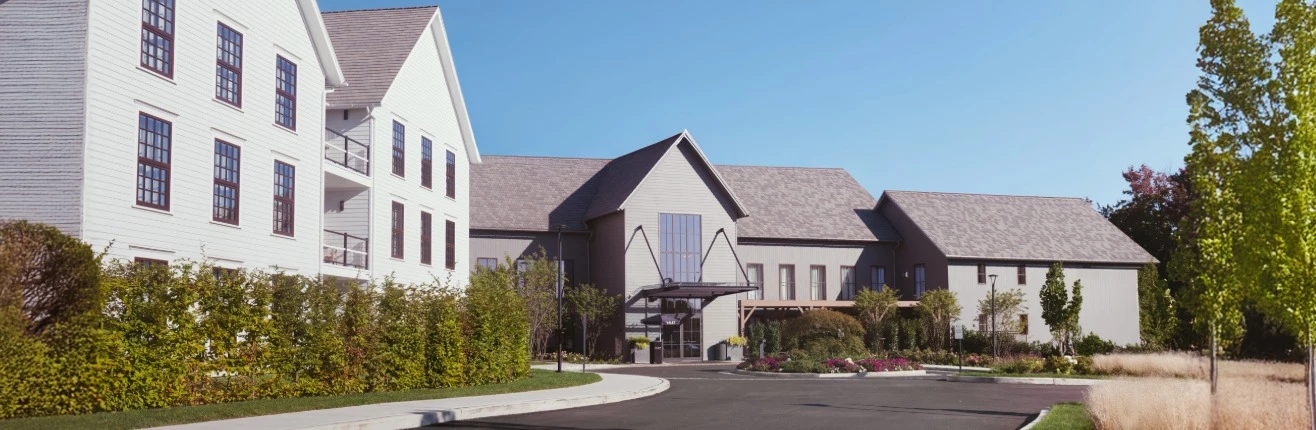 a building with a lot of plants and a parking lot