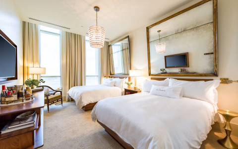 Room with two queen beds, chair & TV