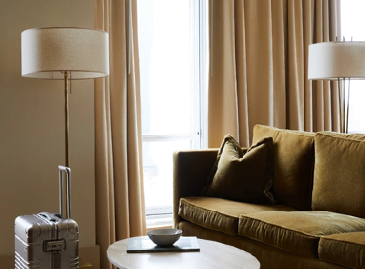 a living room with a couch and a suitcase