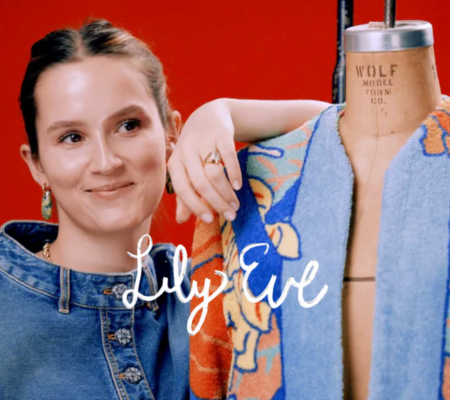 a woman smiling next to a mannequin