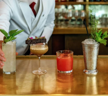 a person holding a bar with drinks