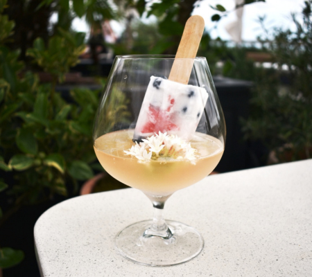 a glass with a popsicle in it