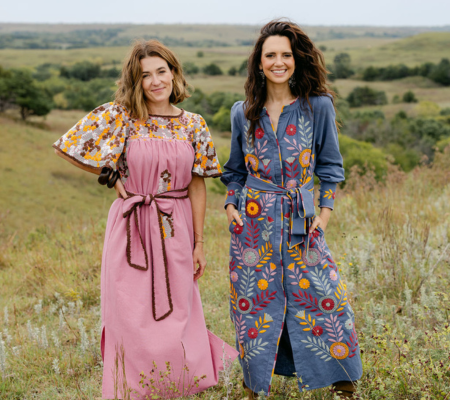 two women standing in a field