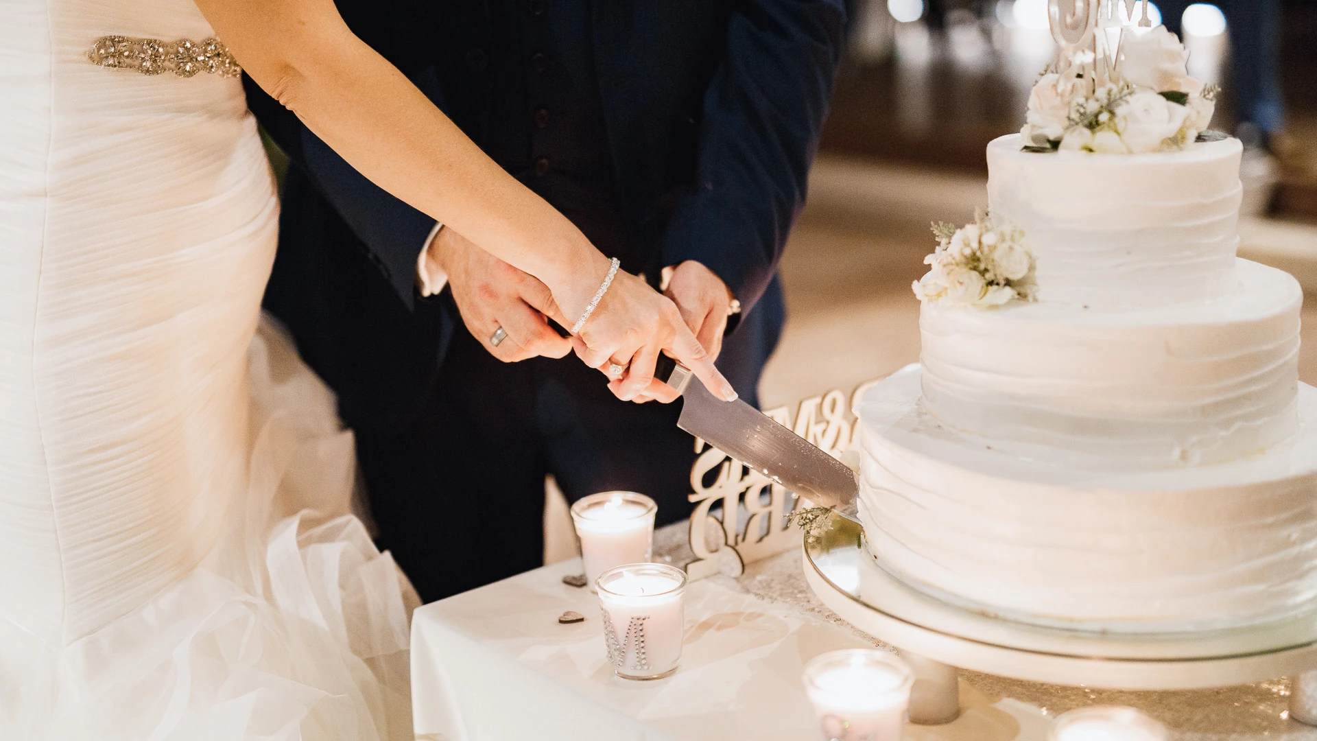 a couple cutting a wedding cake