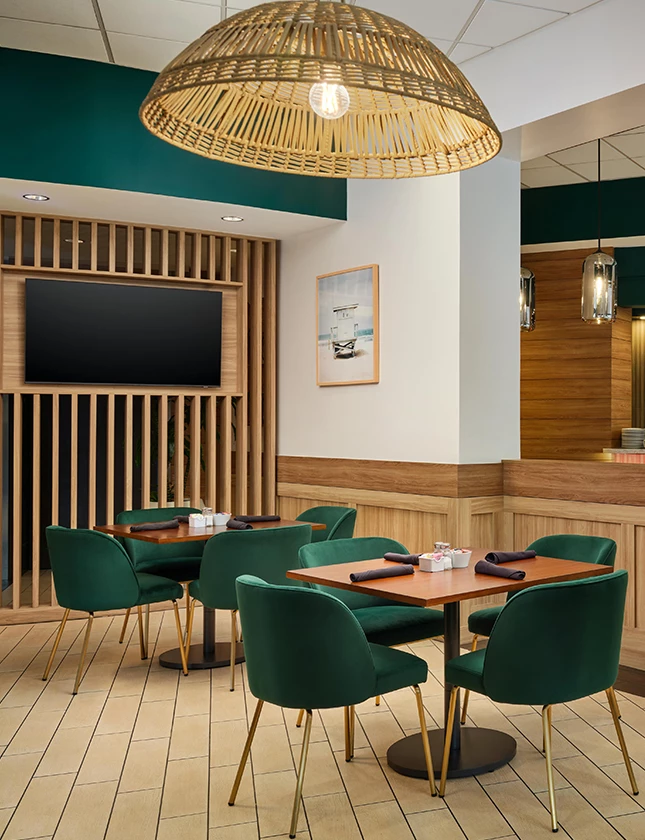 a room with green chairs and a table